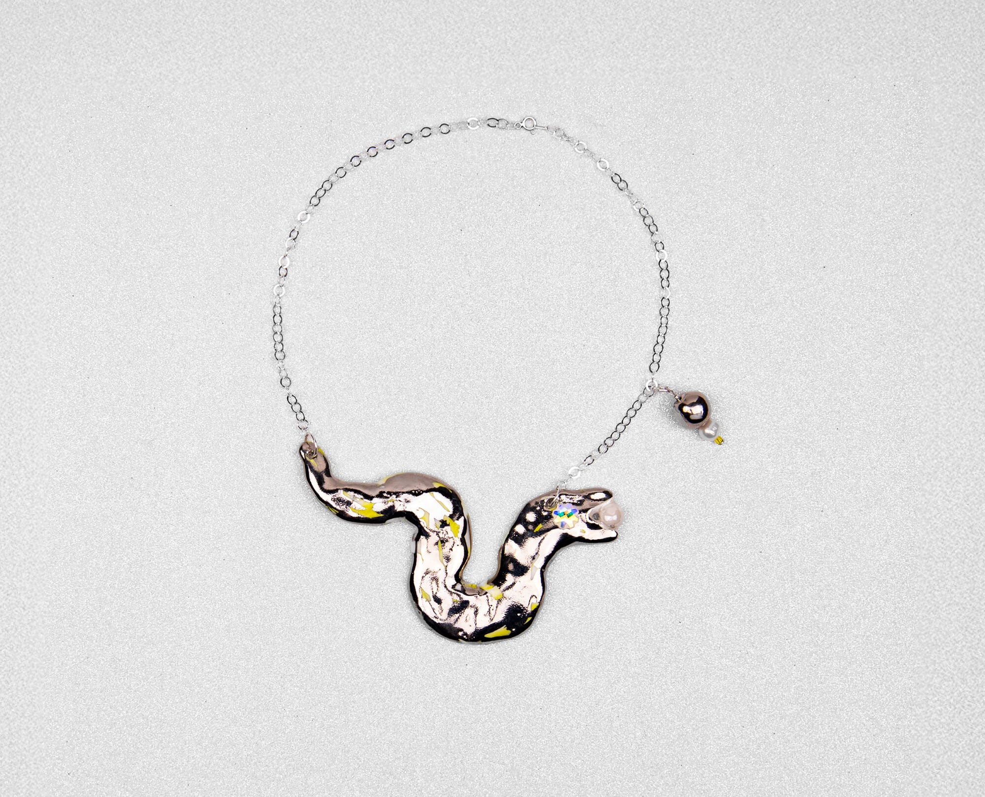 Silver snake chasing pearl necklace