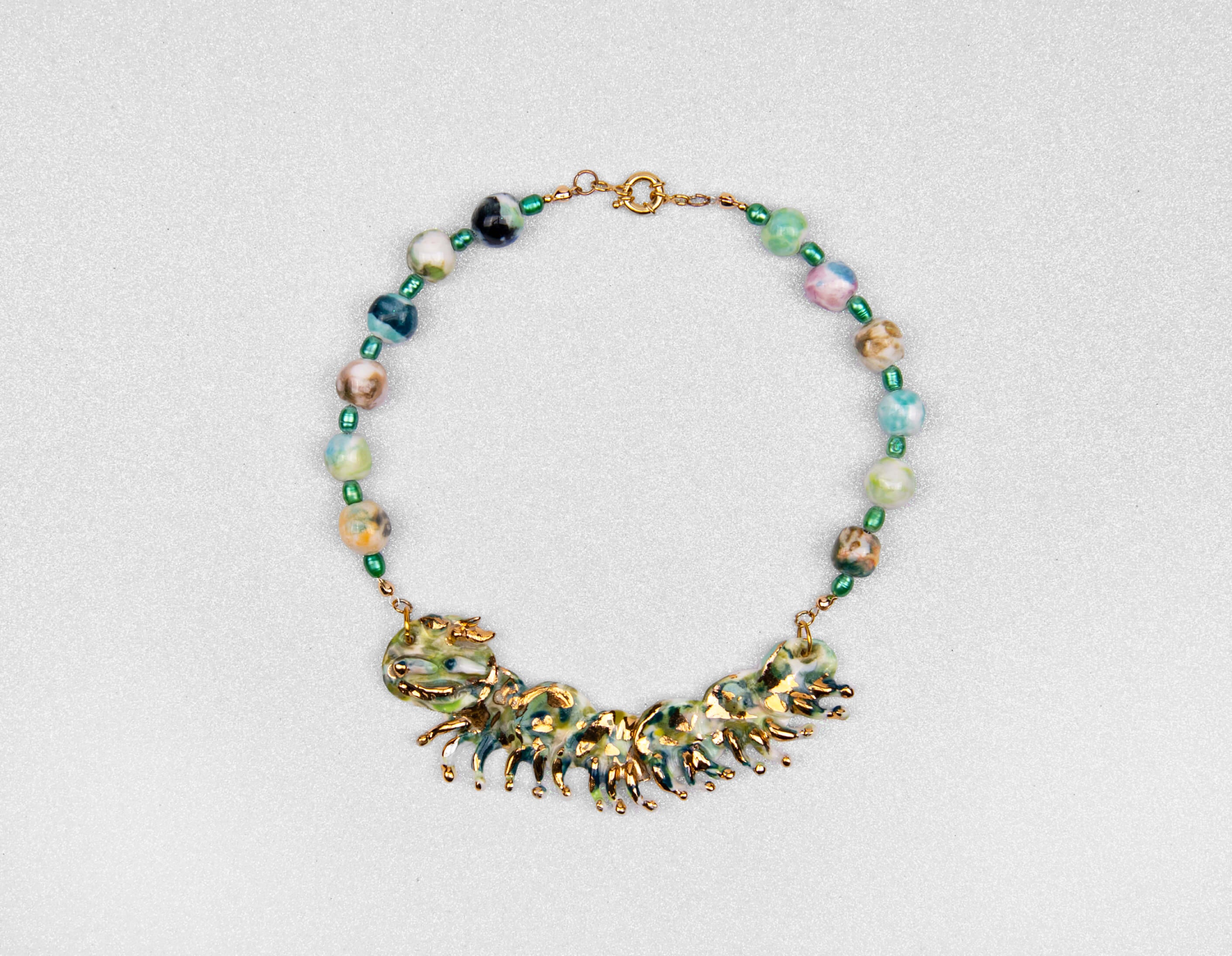 Gold and green caterpillar chocker