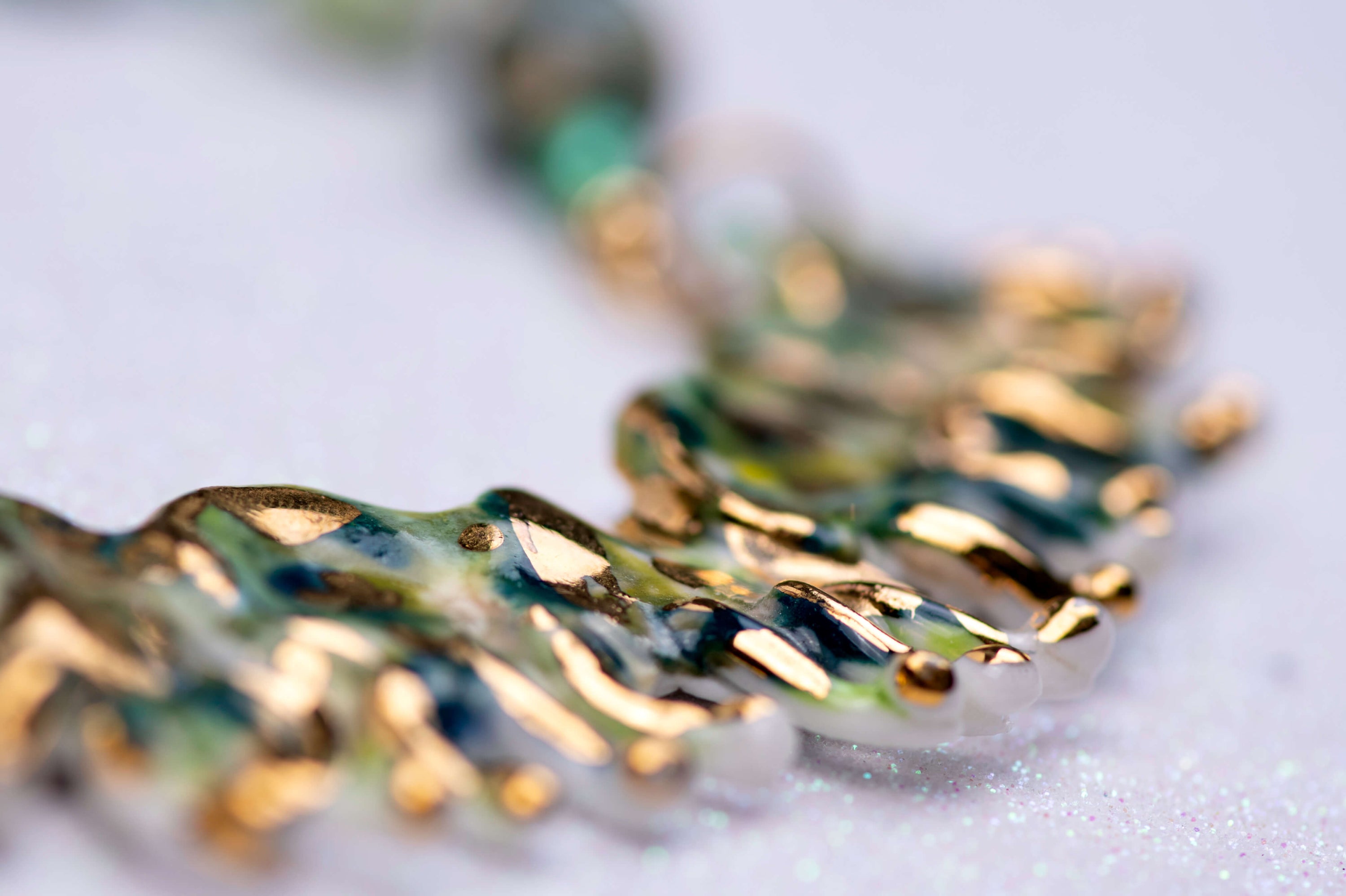 Gold and green caterpillar chocker