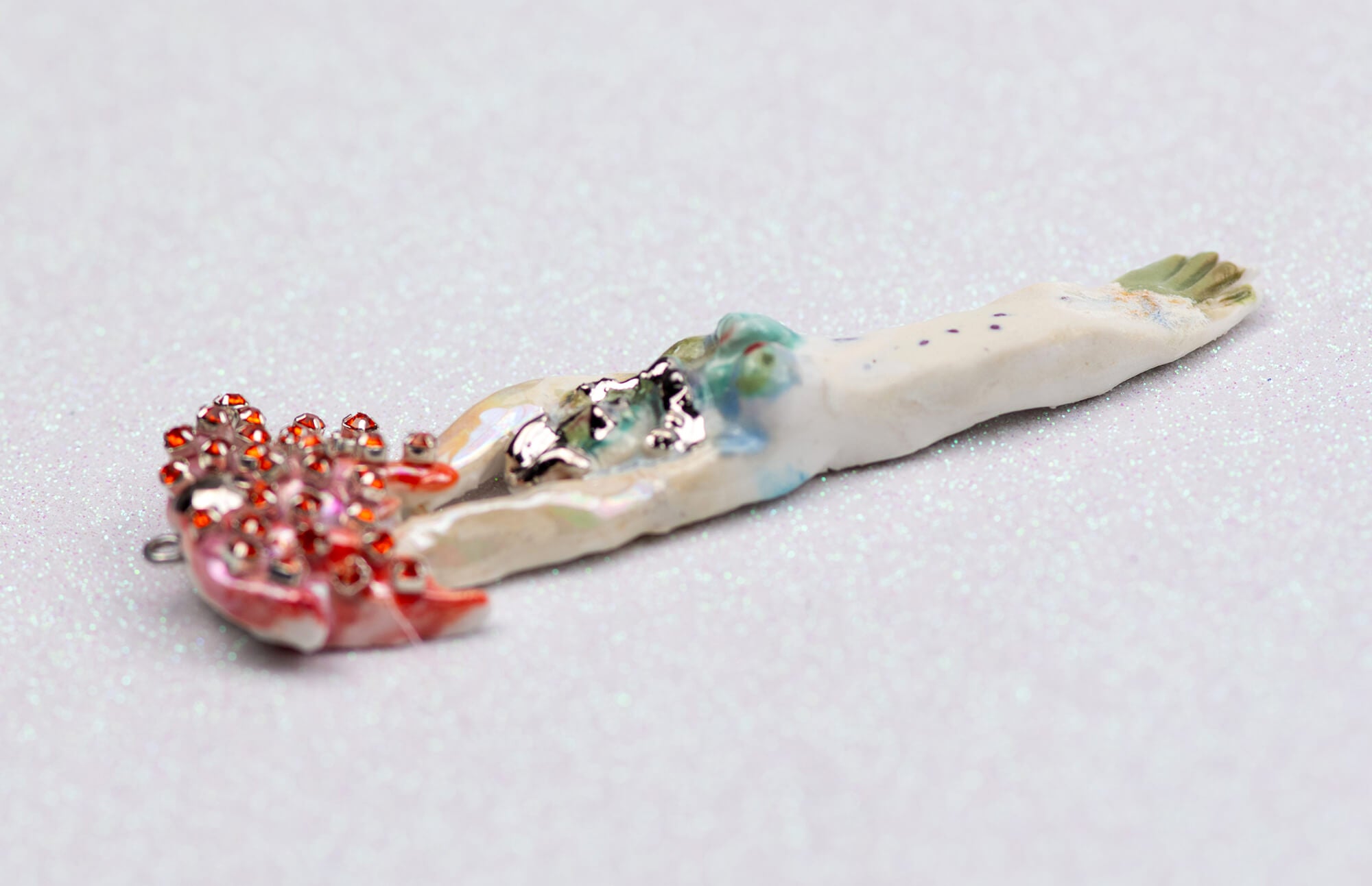 Mermaid carrying red flower charm
