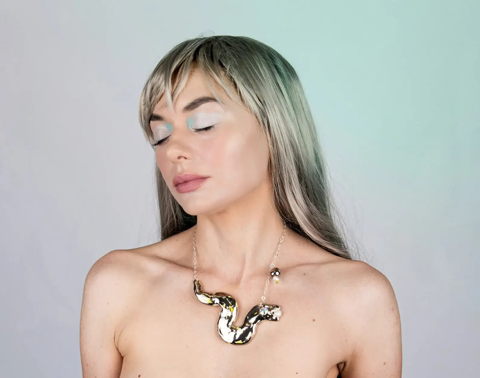 Silver snake chasing pearl necklace