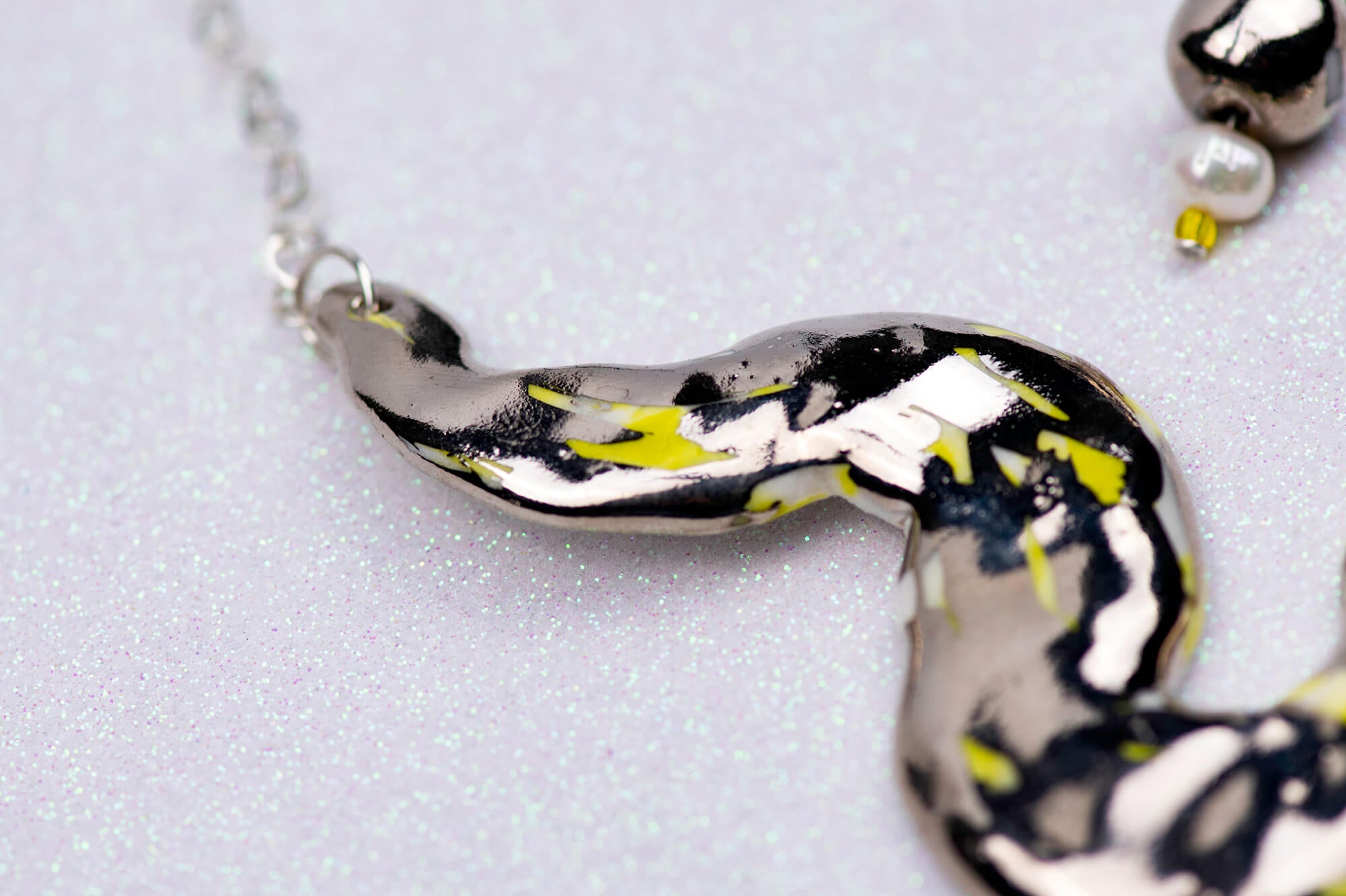 Silver snake chasing pearl necklace