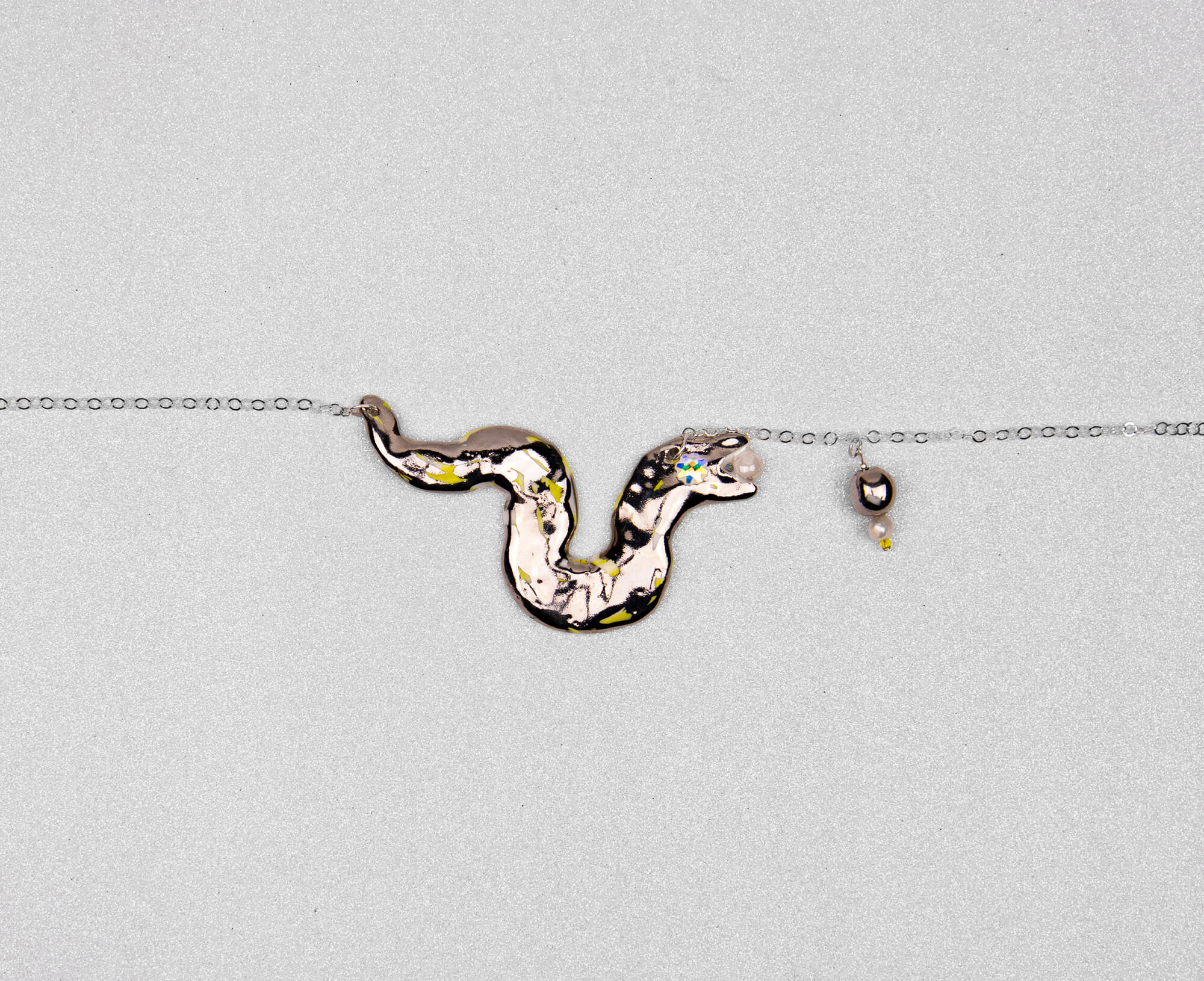 Silver snake chasing pearl necklace