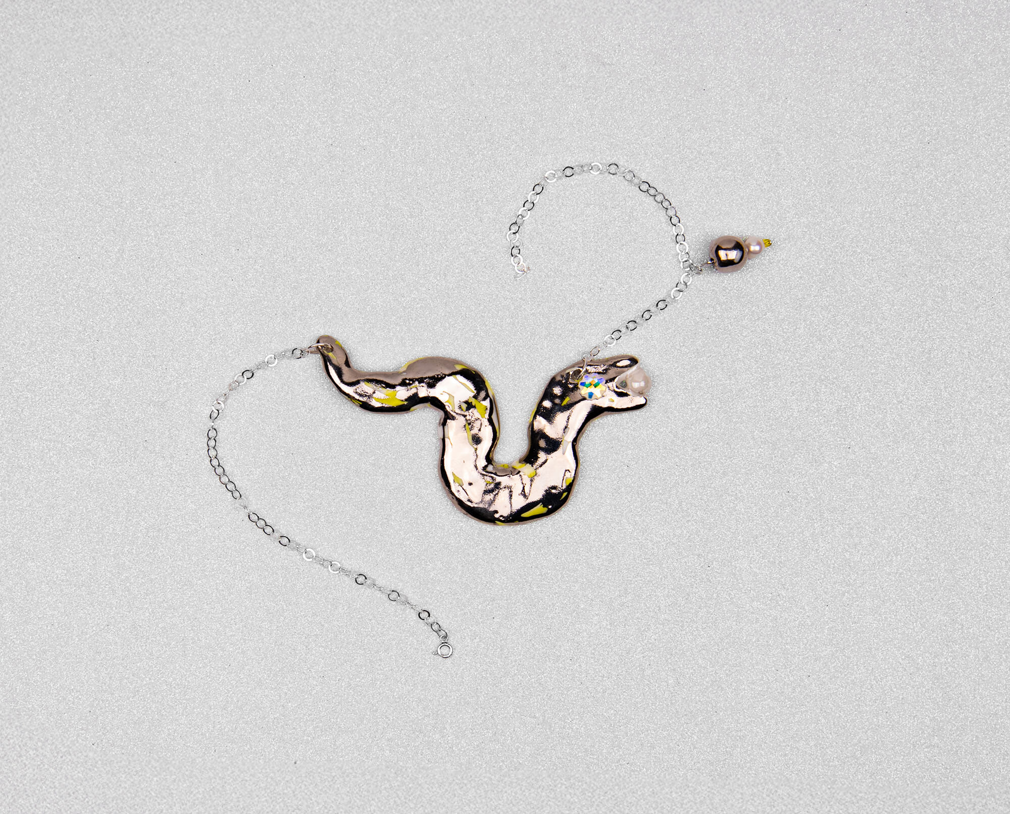 Silver snake chasing pearl necklace